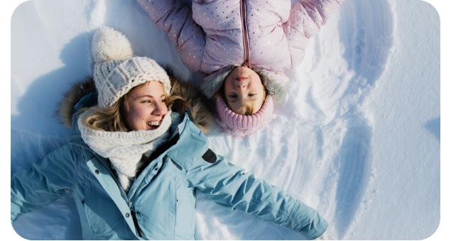 two girls making snow angels