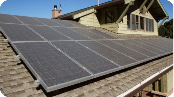 Image of solar panels on a roof of a green cape house