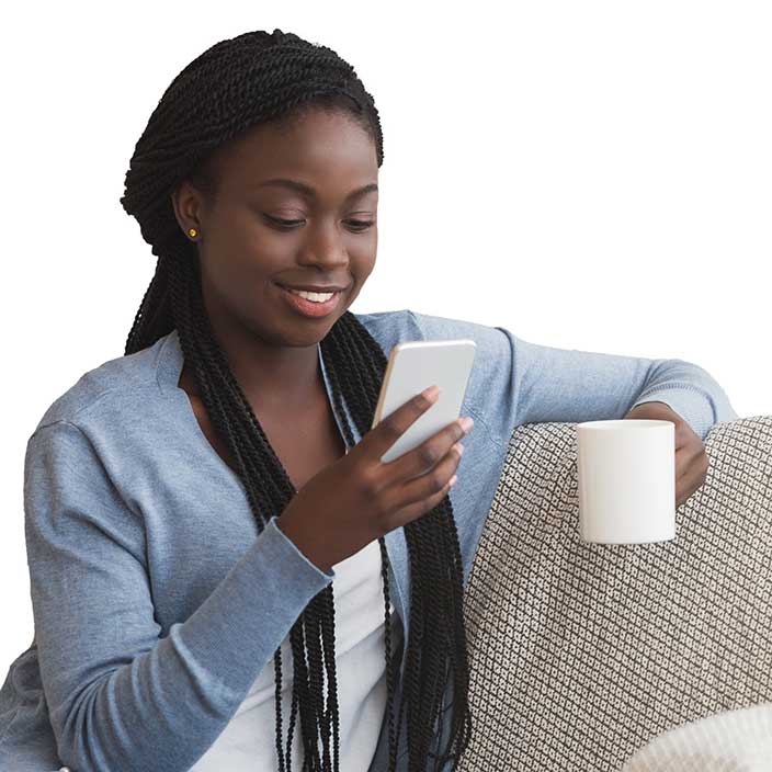 Woman looking at mobile phone and drinking coffee.